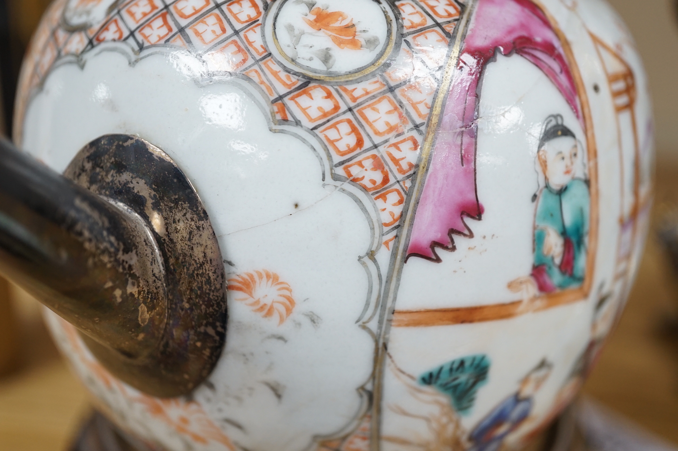 An 18th century Chinese export famille rose teapot with later silver spout and cover, on hardwood stand